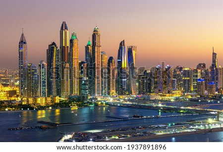 Aerial view on Dubai Marina with skyline - luxury and famous Jumeirah beach frontline at sunrise, United Arab Emirates Royalty-Free Stock Photo #1937891896