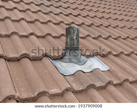 Soil vent pipe on a tiled roof Royalty-Free Stock Photo #1937909008