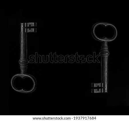 Old metal key isolated on black background. 