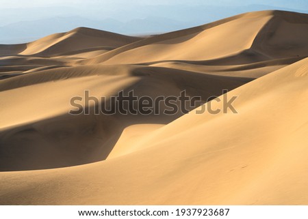Beautiful sand dunes landscape seen at Death Valley National Park, California at sunset Royalty-Free Stock Photo #1937923687