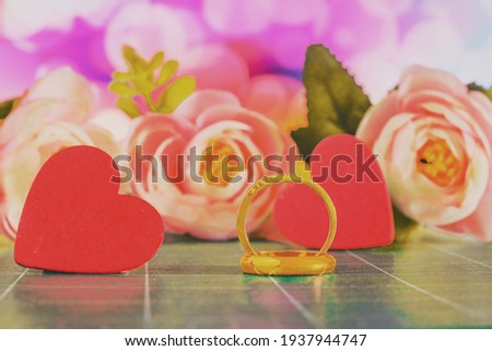 Duo Golden wedding ring with flowers on  background.