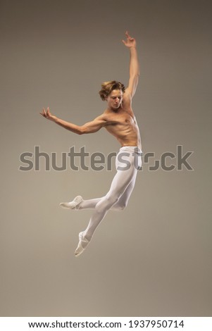 Young and graceful ballet dancer isolated on studio background. Art, motion, action, flexibility, inspiration concept.