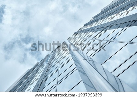 Perspective and underside angle view of modern glass skyscrapers of the building against the blue bright clear sky Royalty-Free Stock Photo #1937953399