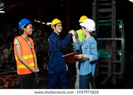 Group of diversity factory employee worker successful about work at the industry factory old garage automotive spare parts warehouse