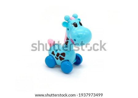 Plastic toy giraffe on a white background.
