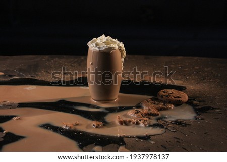 spilled coffee or cocoa with cookies on table