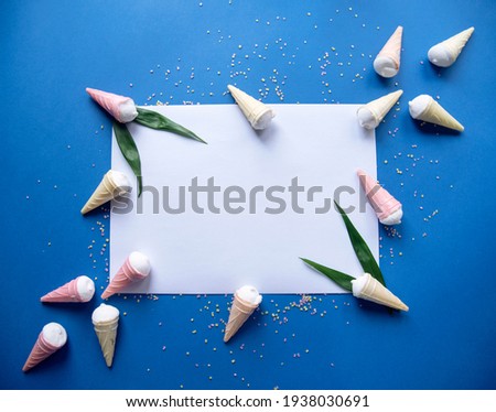 Colorful ice cream pattern on pastel blue background with space for text. Creative minimal summer flat lay.