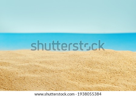 Artificial beach made of cardboard and sand. Stylized sea. The concept of rest, sea and vacation.