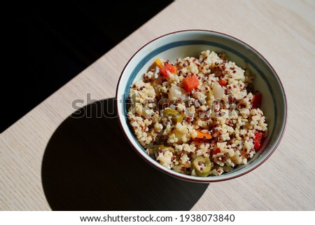 Italian quinoa salad with a bell pepper, green olives, tomatoes - vegetarian, vegan food, minimalist dish, shadow, Japanese bowl