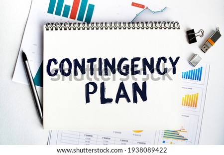Notepad with the inscription CONTINGENCY PLAN. Conceptual image, business accessories, calculator isolated on the desktop. Finance or business concept. Royalty-Free Stock Photo #1938089422
