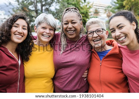 Happy multi generational women having fun together - Multiracial friends smiling on camera after sport workout outdoor - Main focus on african female face Royalty-Free Stock Photo #1938101404