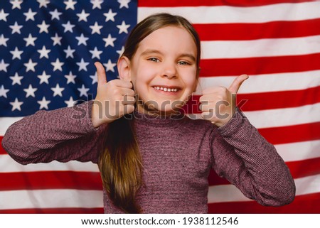 Happy child girl and American Flag Background. Expression of Patriotism and Love for their Country, the United States.