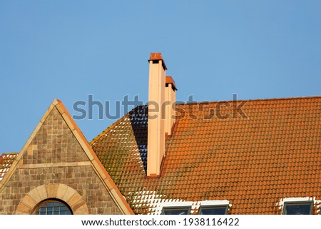 red roof of the house against the blue sky. High quality photo