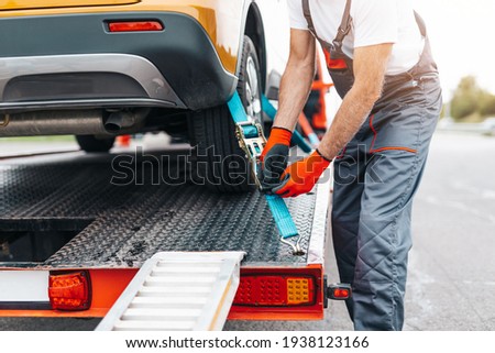 Handsome senior man working in towing service on the road. Roadside assistance concept. Royalty-Free Stock Photo #1938123166