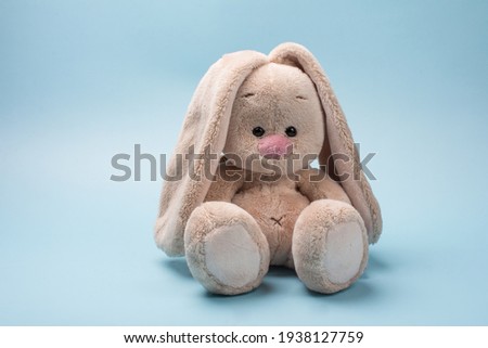 soft toy rabbit. Easter Bunny on a blue background Royalty-Free Stock Photo #1938127759