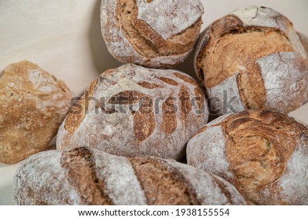 Baked bread in front of a wooden background. Ciabatta croccante