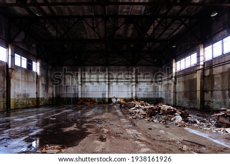 Old broken empty abandoned industrial building interior. Royalty-Free Stock Photo #1938161926
