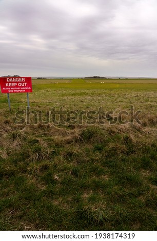 looking down the grass runway of a small military airfield in wiltshire