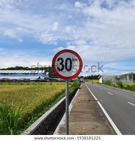 The road speed sign ,  rice field  background