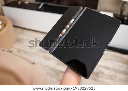 Female hands hold a digital tablet close-up, top view. New technology concept, multimedia