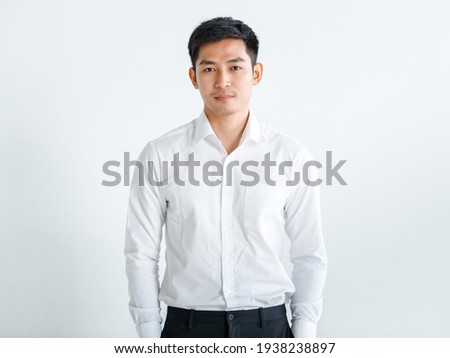 Young, handsome and friendly face man smile, dressed casually with happy and self-confident positive expression with crossed arms on white background studio shot. Concept for good attitude boy. Royalty-Free Stock Photo #1938238897