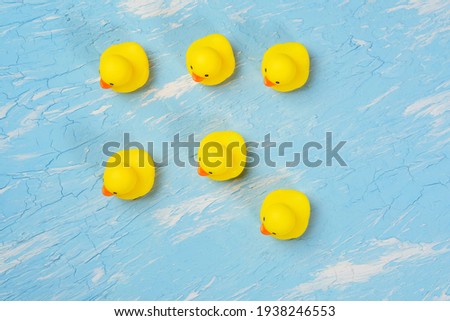 yellow rubber ducks on a blue background. Minimal design