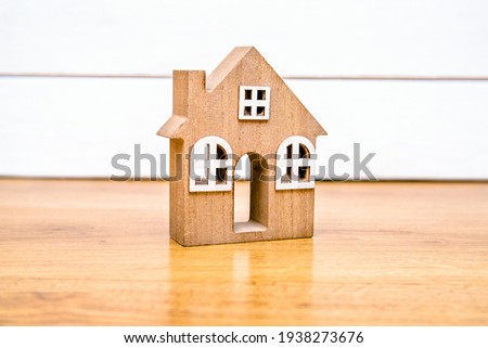 The symbol of the house on a white wooden background 