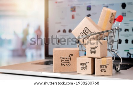 paper boxes parcel in a trolley on laptop in shopping mall. concept shopping online and service home delivery.black friday concept Royalty-Free Stock Photo #1938280768