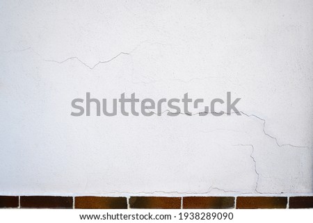 Cracks outside on the wall in plaster. Royalty-Free Stock Photo #1938289090