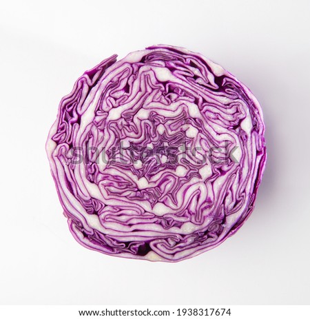 An isolated photo of sliced red cabbage from top. Close up of an intricate pattern of purple color cabbage after slicing it. Fresh vegetable cross section. Royalty-Free Stock Photo #1938317674