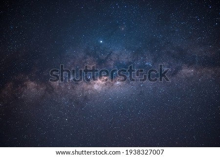 Milky way is visible in the dark night sky. Beautiful starry background with galaxy nebula Royalty-Free Stock Photo #1938327007