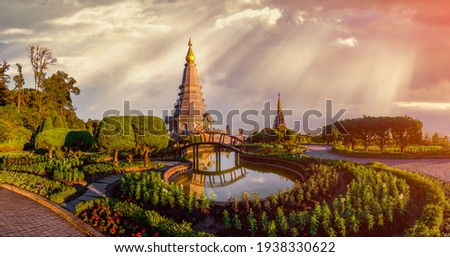 Panolama landscape of two pagoda in Doi Inthanon Mountain with evening orange light splashed at the pagoda in sunset, Chaingmai, Thailand Royalty-Free Stock Photo #1938330622