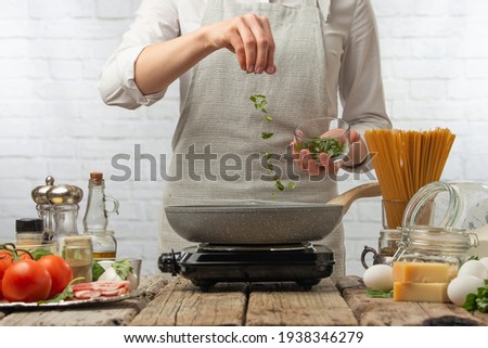 chef cooks in a skillet, fry, tosses greens Freeze in motion Recipes, illustrations for cooking books or magazines