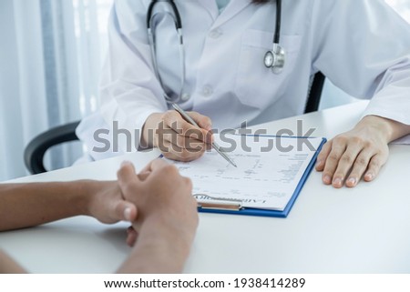 hand holding pen, Doctors report health examination results and recommend medication to patients, medical checkup concept.