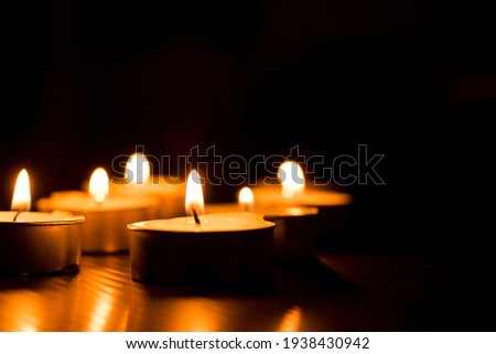 candles that are lit in the dark Royalty-Free Stock Photo #1938430942
