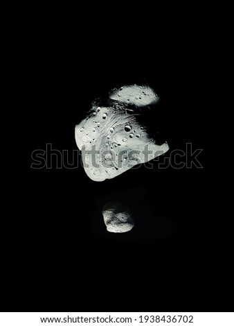 two asteroids with craters in space, asteroid with satellite