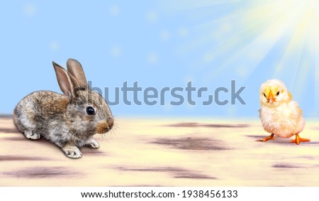 An Easter card with a rabbit, an Easter chicken and painted eggs in a basket on a wooden table. Blurred background with bokeh.