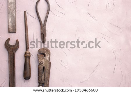 Fathers day or labor day greeting card concept. Vintage old tools on grey concrete background. Copy space