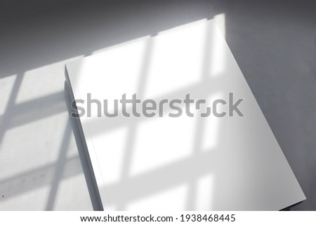Blank cover page of the thick textbook in stripe pattern shadow from daylight for modern arts, design, or architecture publishing advertising mockup.