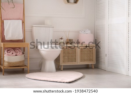 Stylish bathroom interior with toilet bowl and other essentials Royalty-Free Stock Photo #1938472540