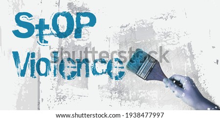 Stop Violence message on wall with paintbrush in hand. Domestic abuse prevention social concept