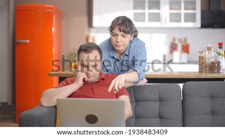 Young couple is shopping online from the computer. A young couple browsing online shopping sites looking for products. Online shopping concept.  Royalty-Free Stock Photo #1938483409