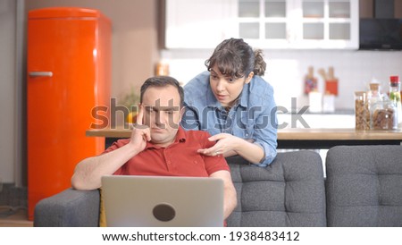 Young couple is shopping online from the computer. A young couple browsing online shopping sites looking for products. Online shopping concept.  Royalty-Free Stock Photo #1938483412
