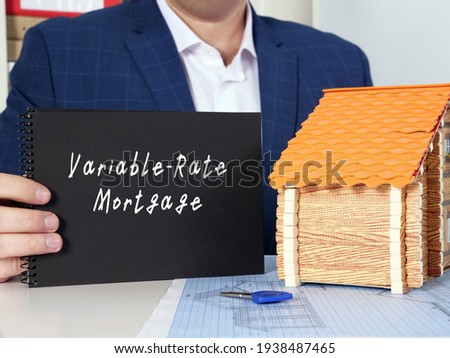 Young woman holding a blank card in hands. Conceptual photo about Variable-Rate Mortgage with written text. 
