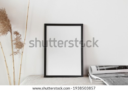 blank frame  on wall with magazine