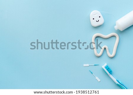 Oral care products flat lay. Toothbrushes with white tube of toothpaste and dental floss Royalty-Free Stock Photo #1938512761
