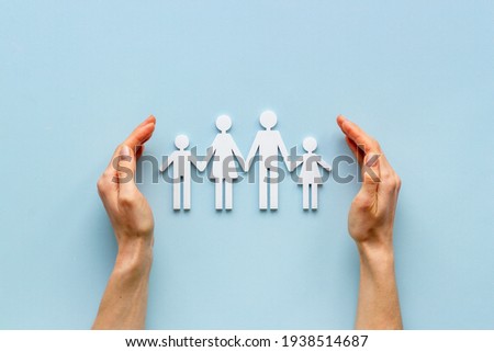 Hands holding family figure top view. Insurance concept Royalty-Free Stock Photo #1938514687