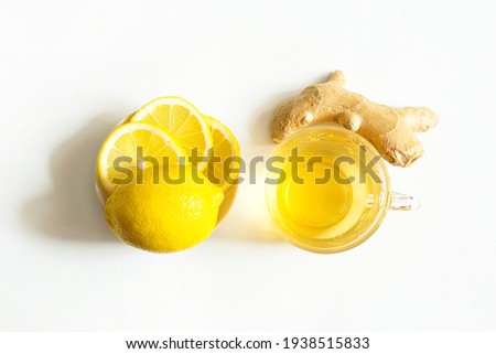 Medicinal tea in a cup, ginger, lemon-strengthen the immune system in the cold season. Vitamin drink for health and ingredients on a white background.