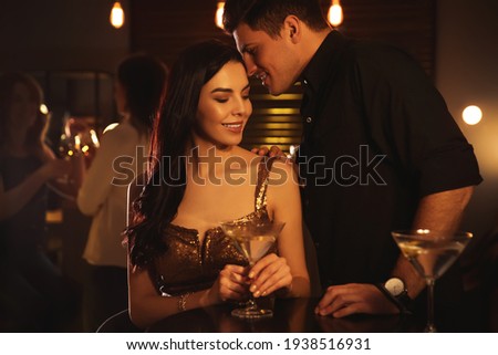 Man and woman flirting with each other in bar Royalty-Free Stock Photo #1938516931