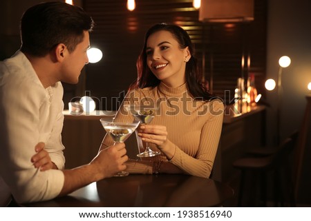 Man and woman flirting with each other in bar Royalty-Free Stock Photo #1938516940
